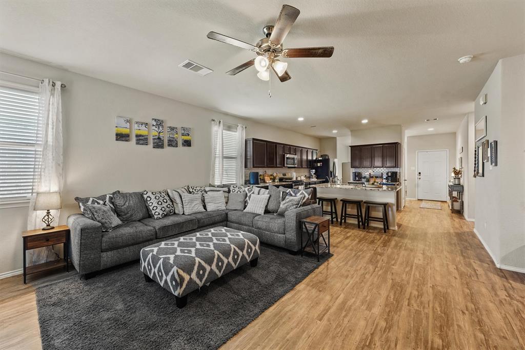 a living room with furniture and kitchen view