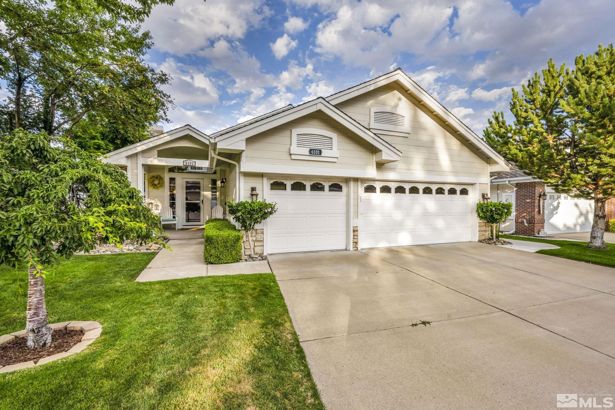 a front view of a house with a yard and garage