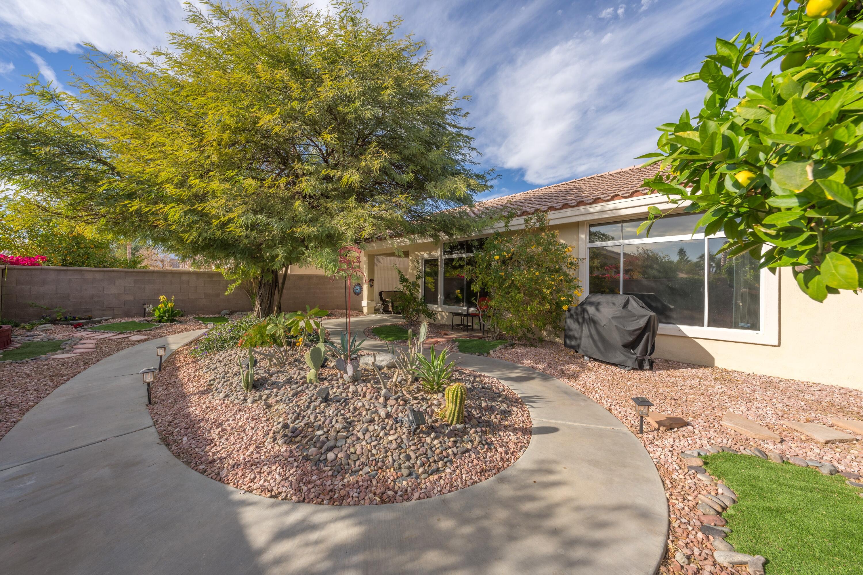 a view of a house with backyard and sitting area