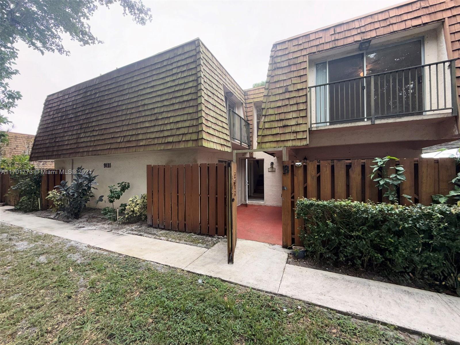 a view of a house with a yard and plants