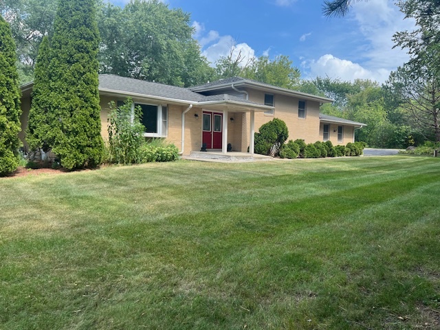 a front view of house with yard and green space