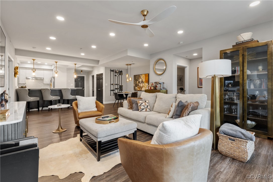 a living room with furniture and wooden floor