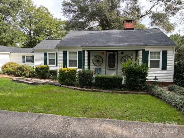 a view of a house with garden and yard