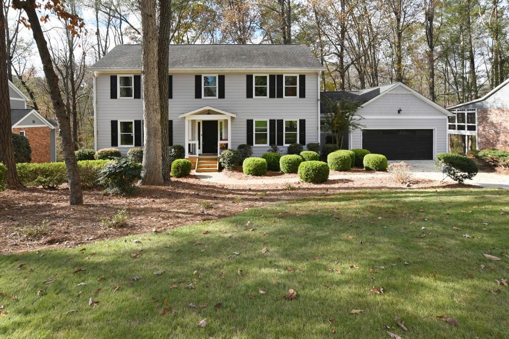 a front view of a house with outdoor seating