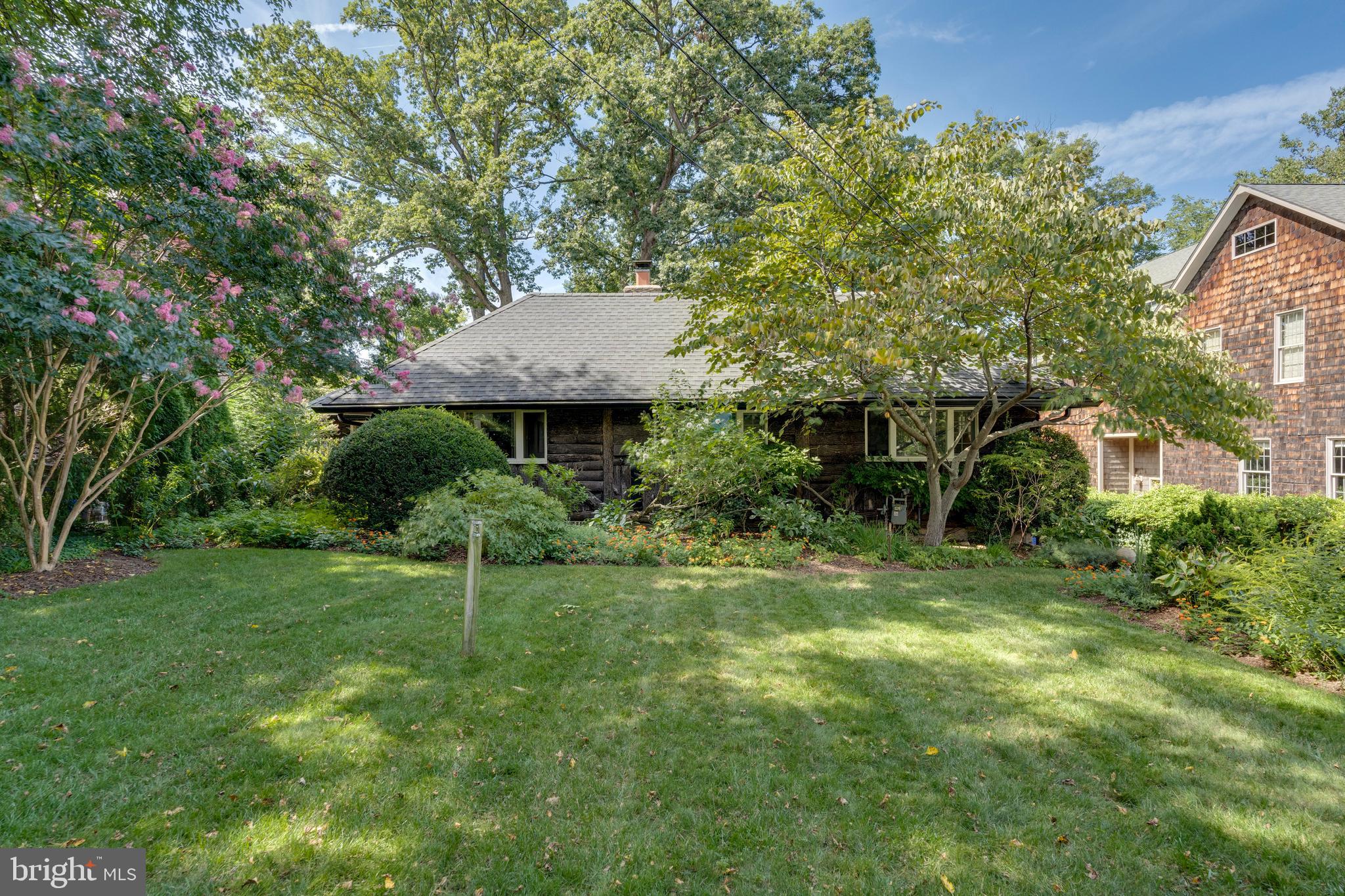 a view of a house with a yard and sitting area