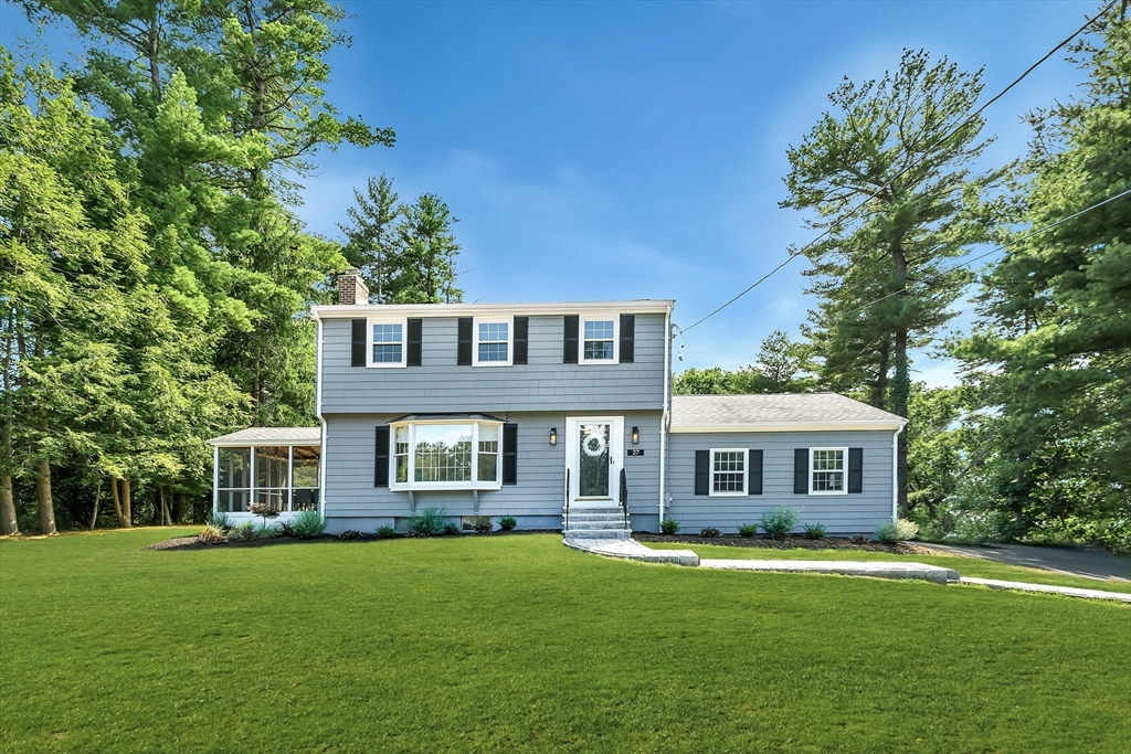 a front view of a house with a garden