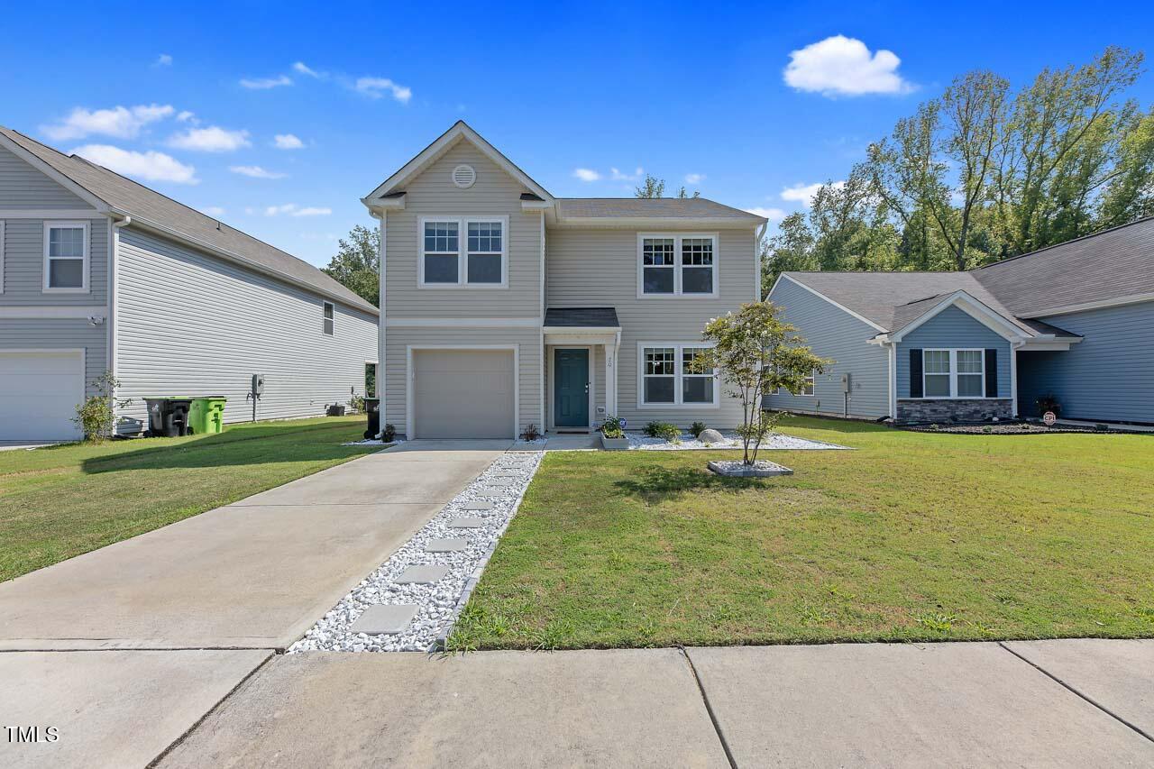 a front view of a house with a yard