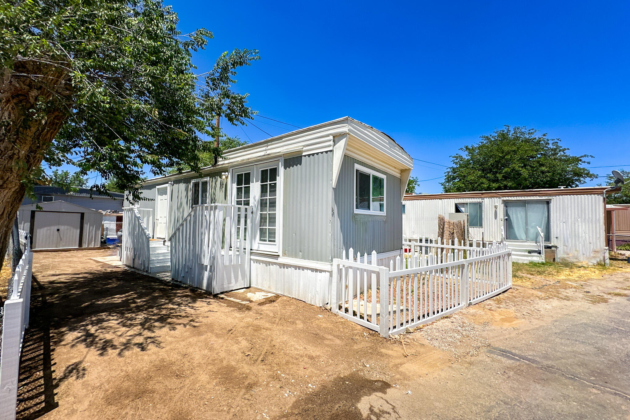 a view of a house with a wooden fence