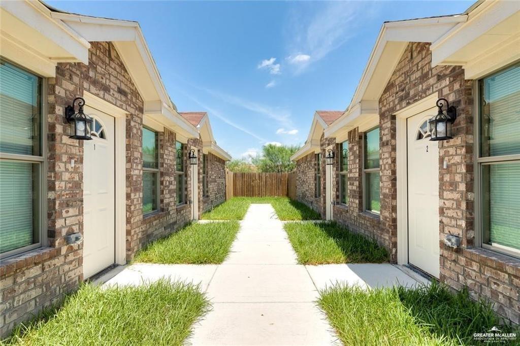 a view of a pathway both side of house