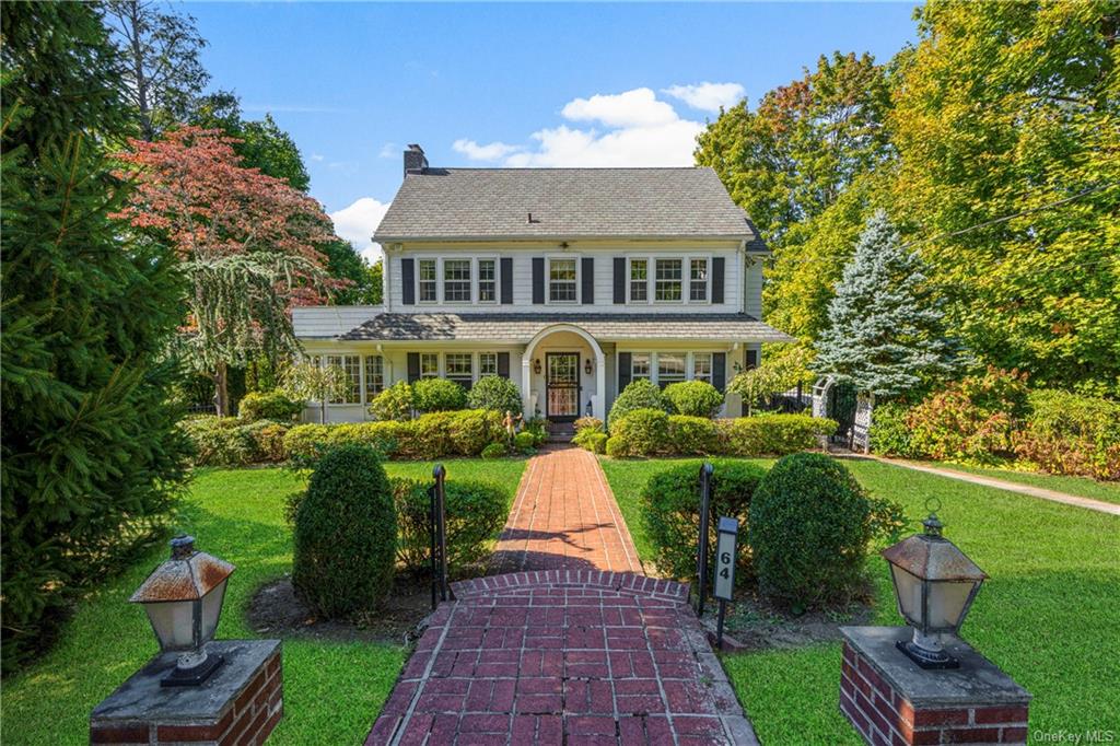 Colonial-style house featuring a front lawn