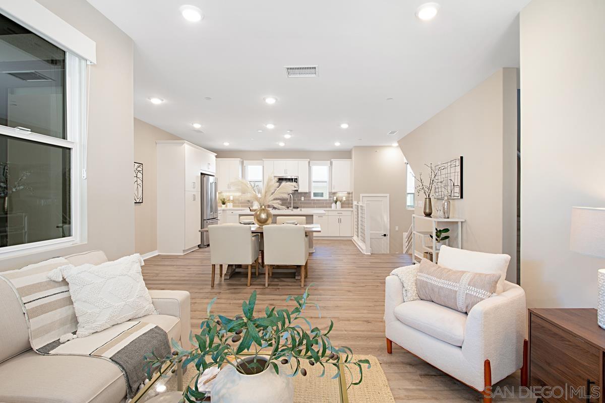 a living room with furniture kitchen and a table