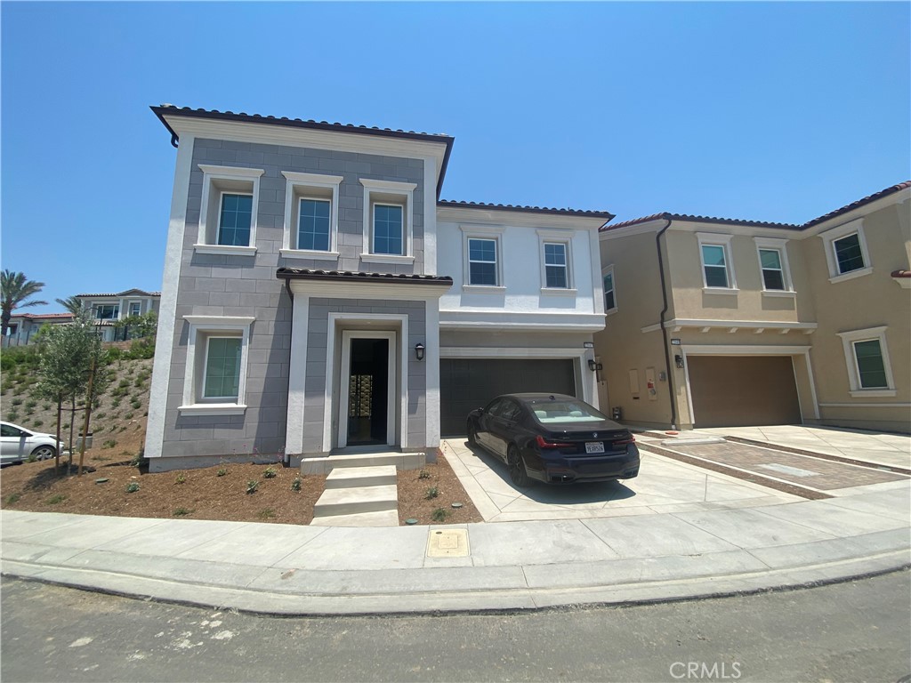 a view of a house with car parked