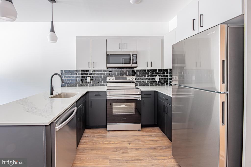 a kitchen with a refrigerator sink and stove