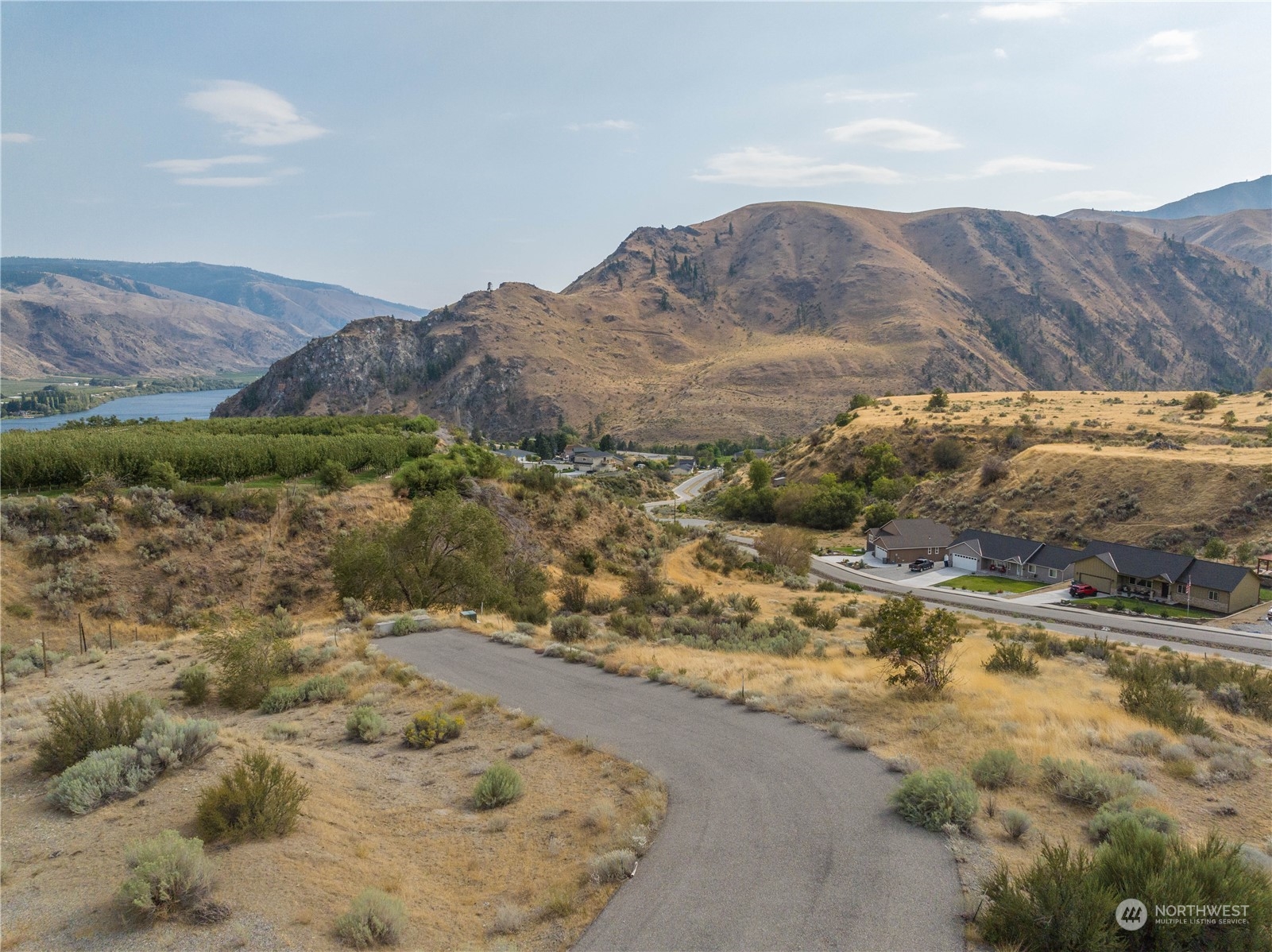 a view of a mountain with a field