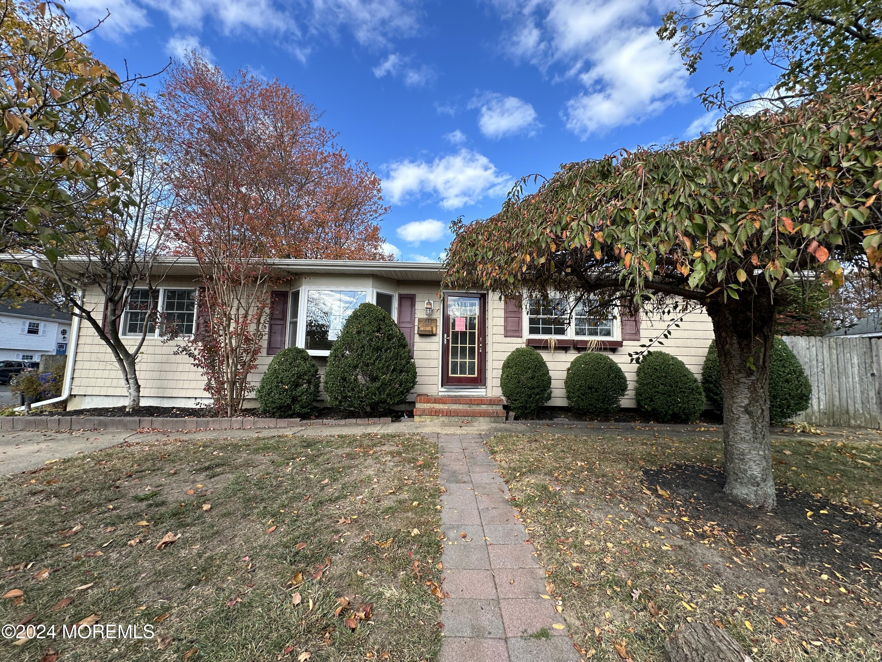 a view of a house with a tree in front of it