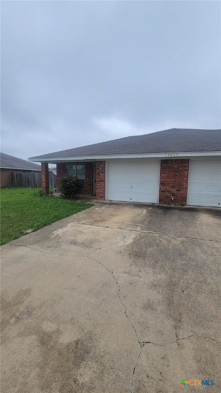 a view of a house with a yard and garage