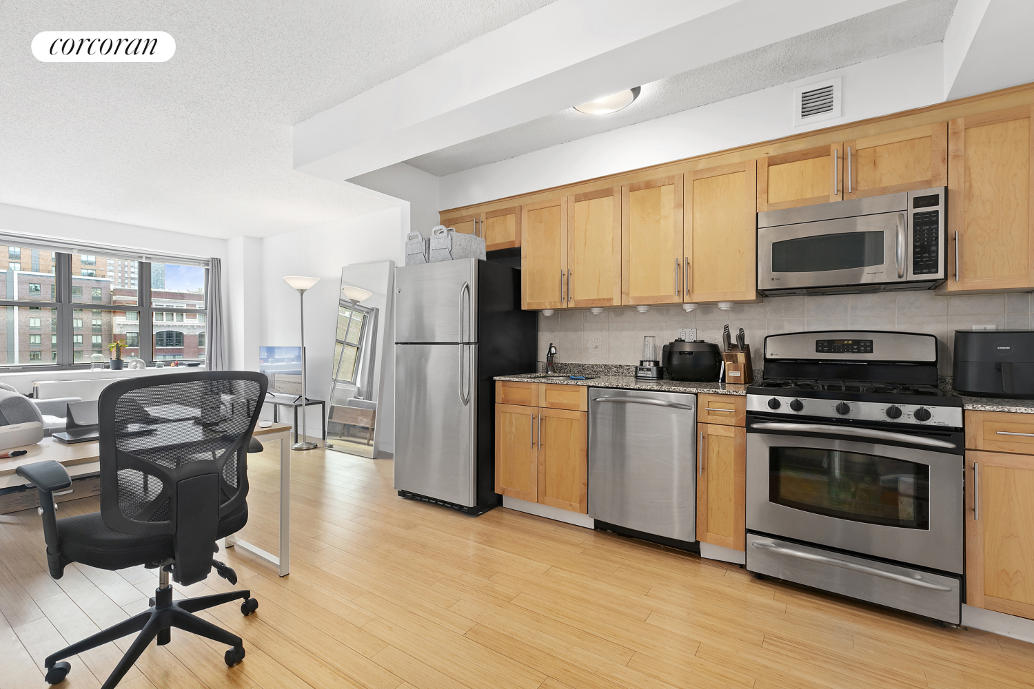 a kitchen with a refrigerator stove and microwave