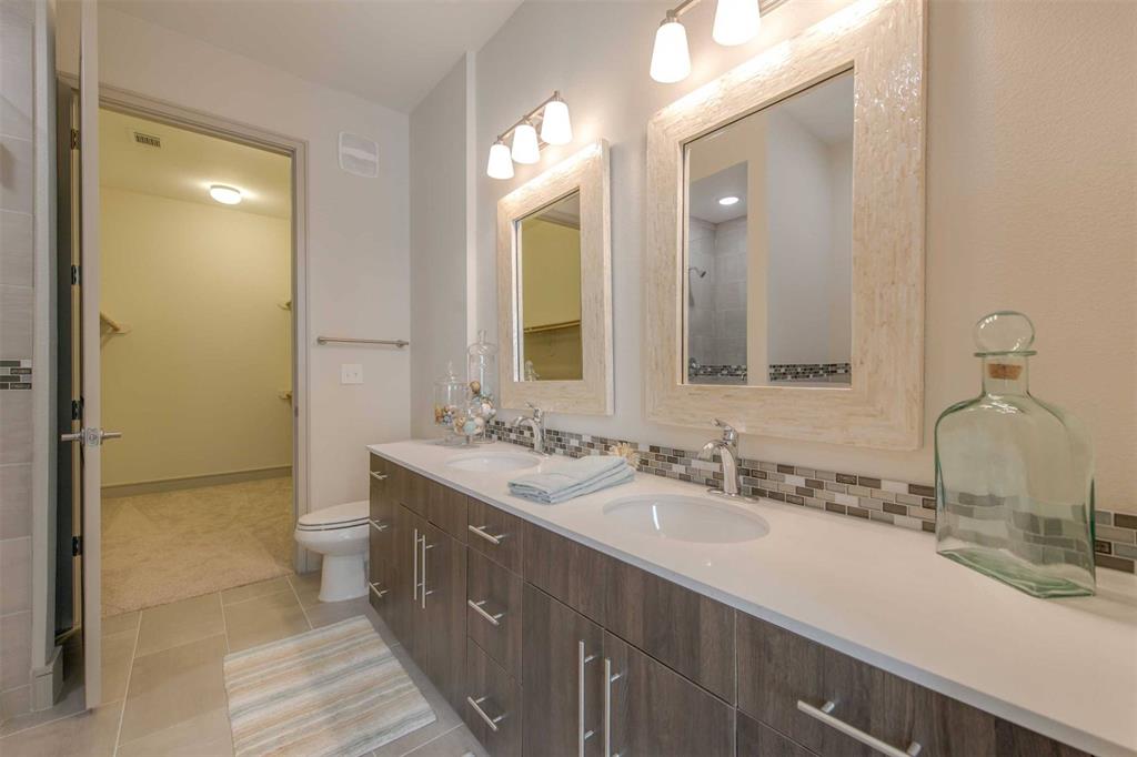 a bathroom with a double vanity sink mirror and double