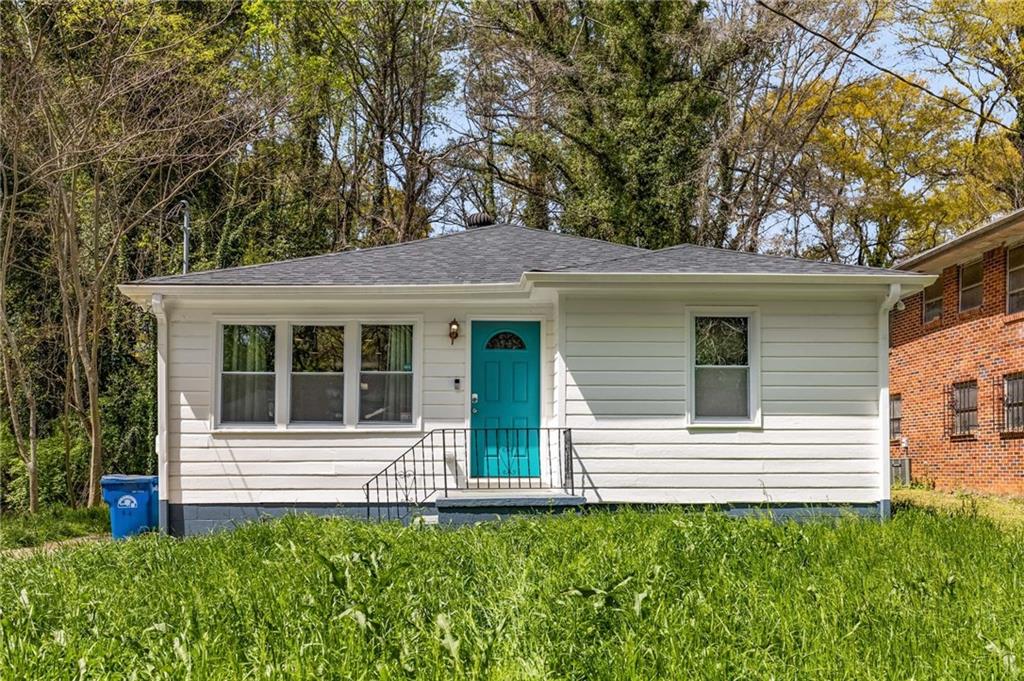 a view of a house with a small backyard