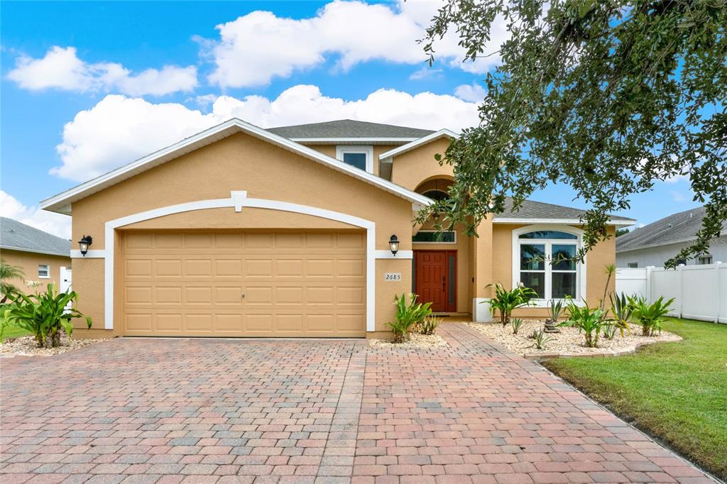 a front view of a house with a yard and garage