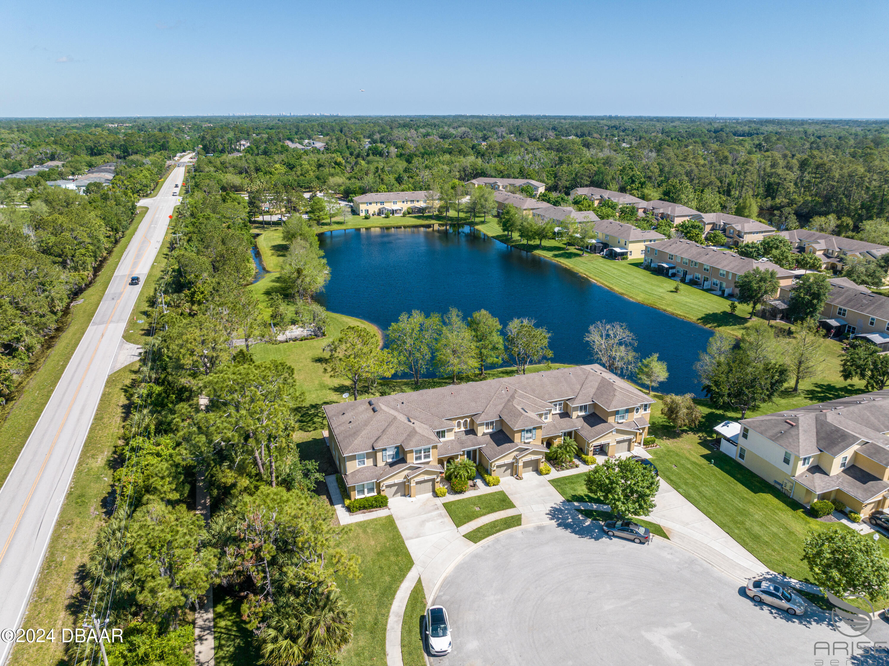 an aerial view of residential houses with outdoor space and river