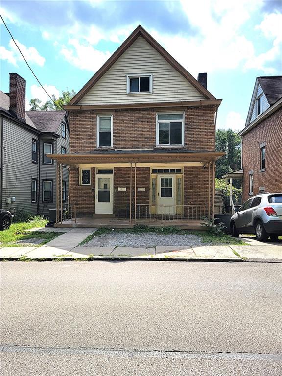 a front view of a house with a yard and a garage