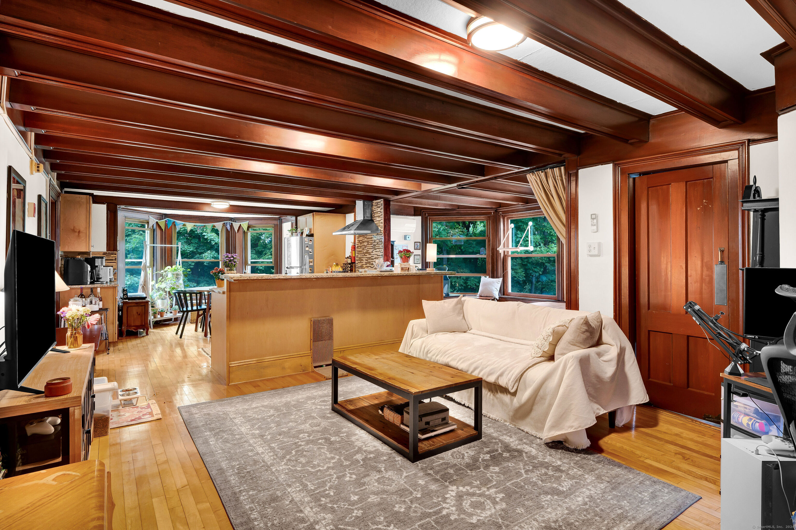 a living room with patio furniture and a fireplace