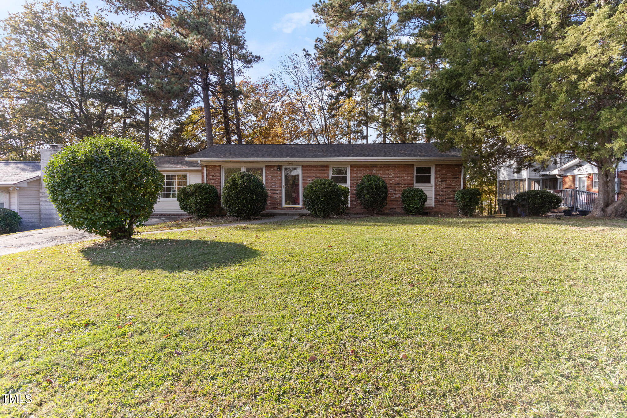 a view of a house with a yard and trees