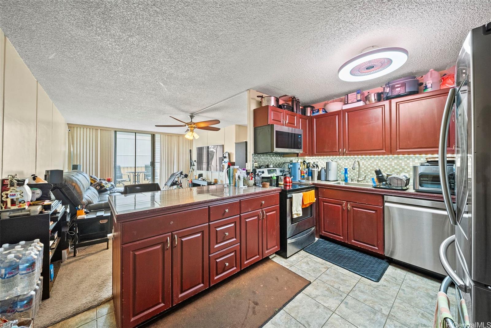 a large kitchen with stainless steel appliances granite countertop a sink and cabinets