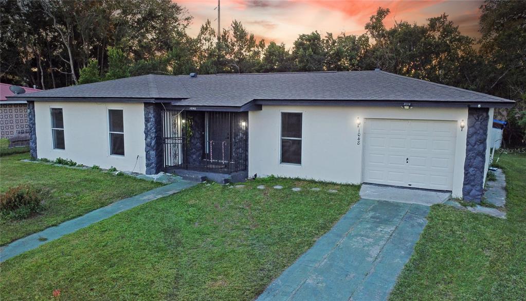 a aerial view of a house next to a yard and garage