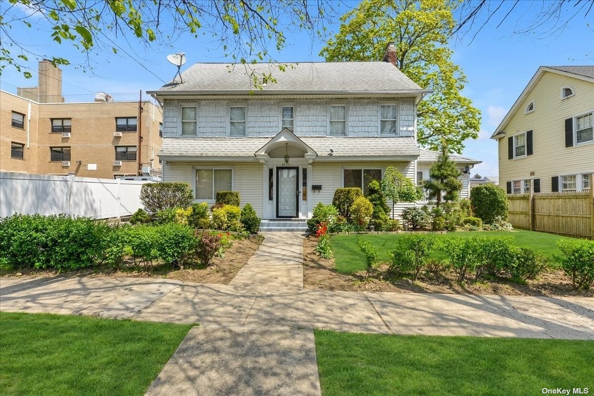 a front view of a house with garden