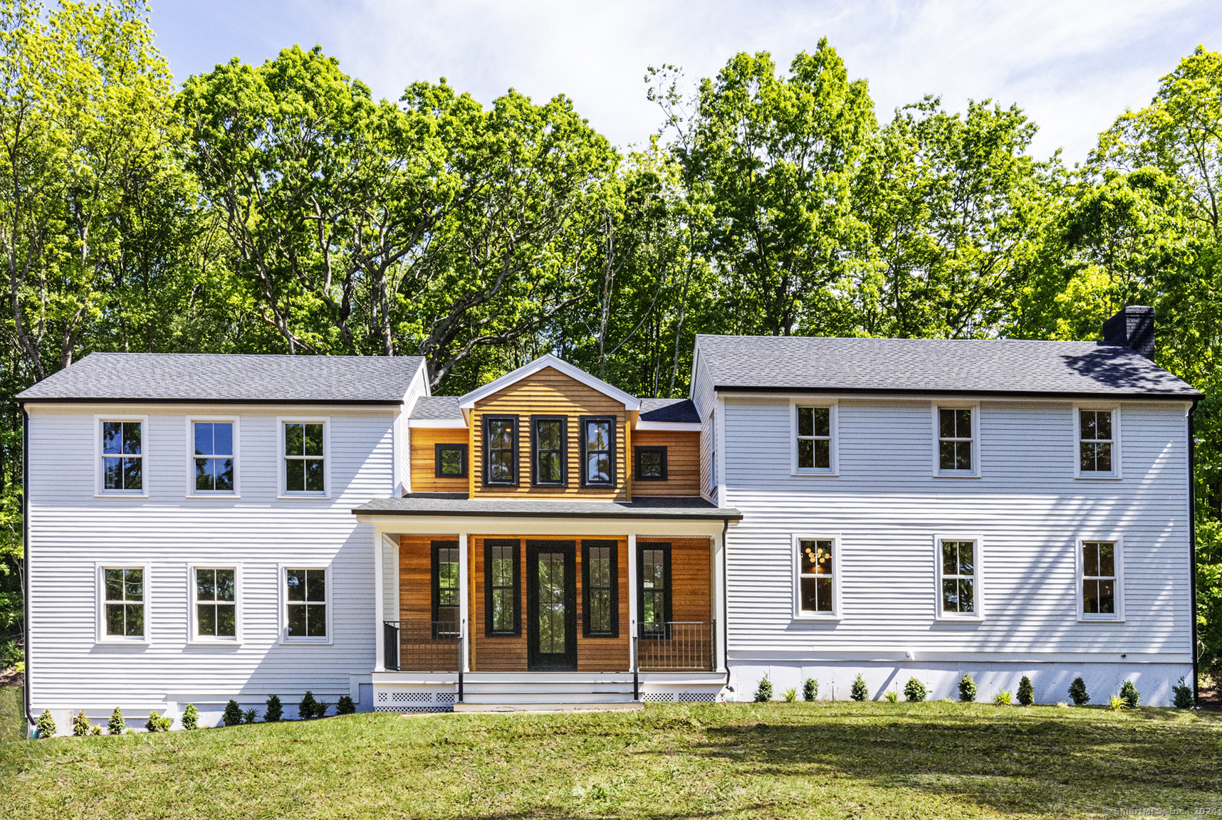 a front view of a house with a garden