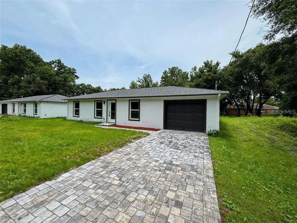 a front view of house with yard and green space