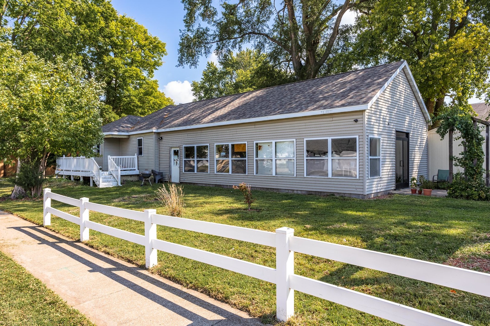 a view of a house with a yard patio and swimming pool