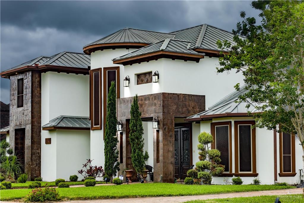 a front view of a house with garden