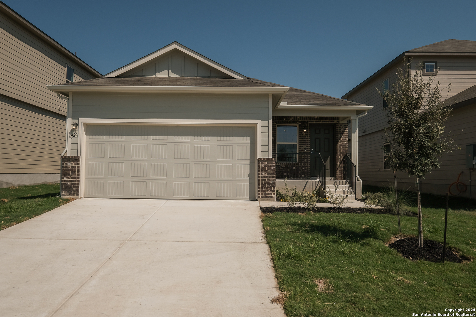 a front view of a house with a yard