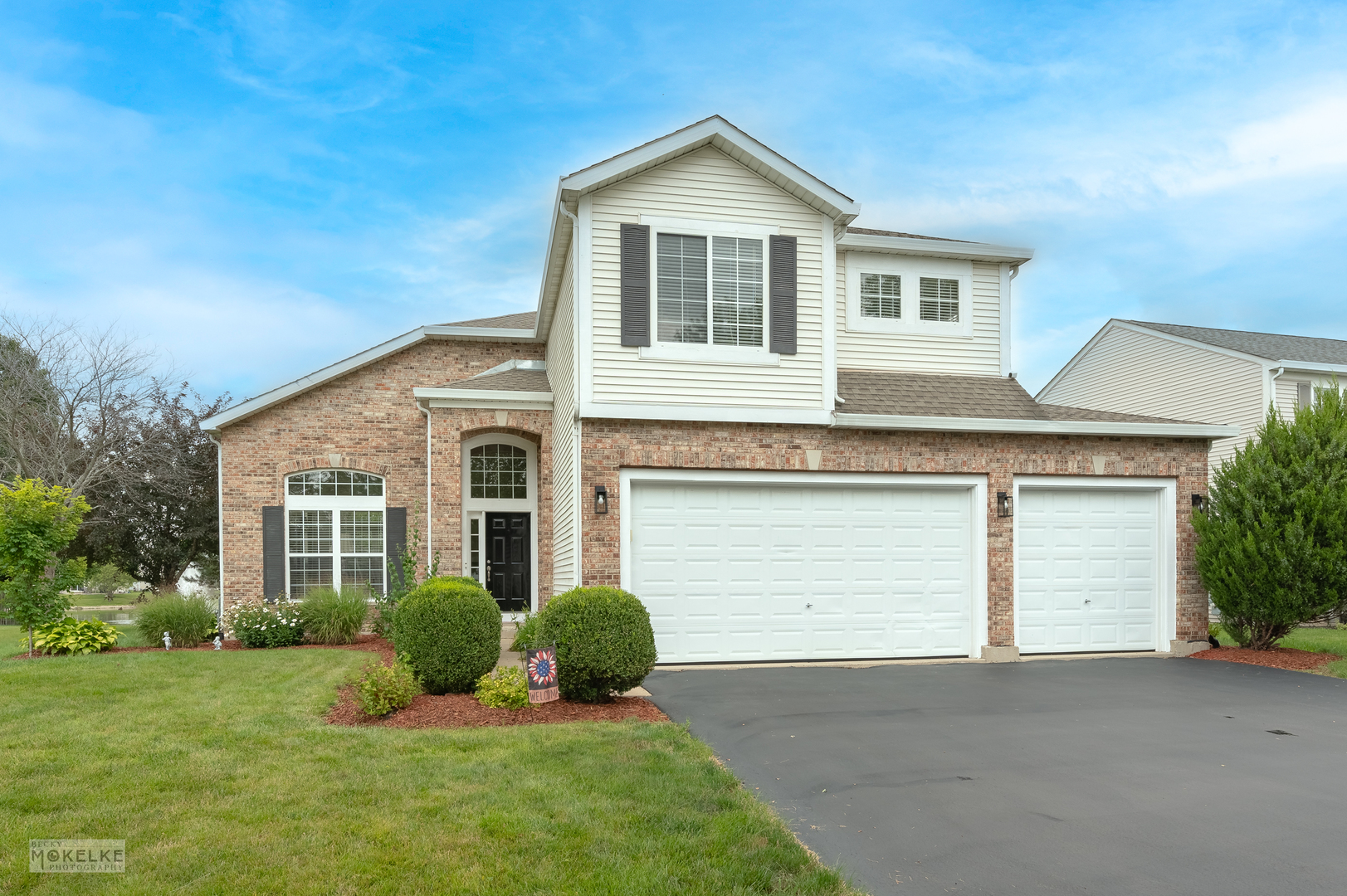 a front view of a house with a yard and garage