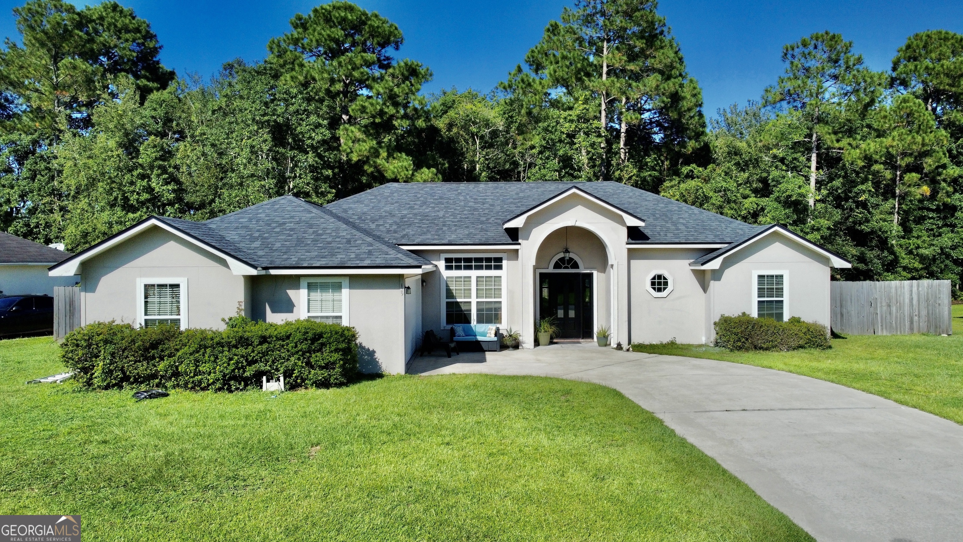 a front view of house with yard and green space