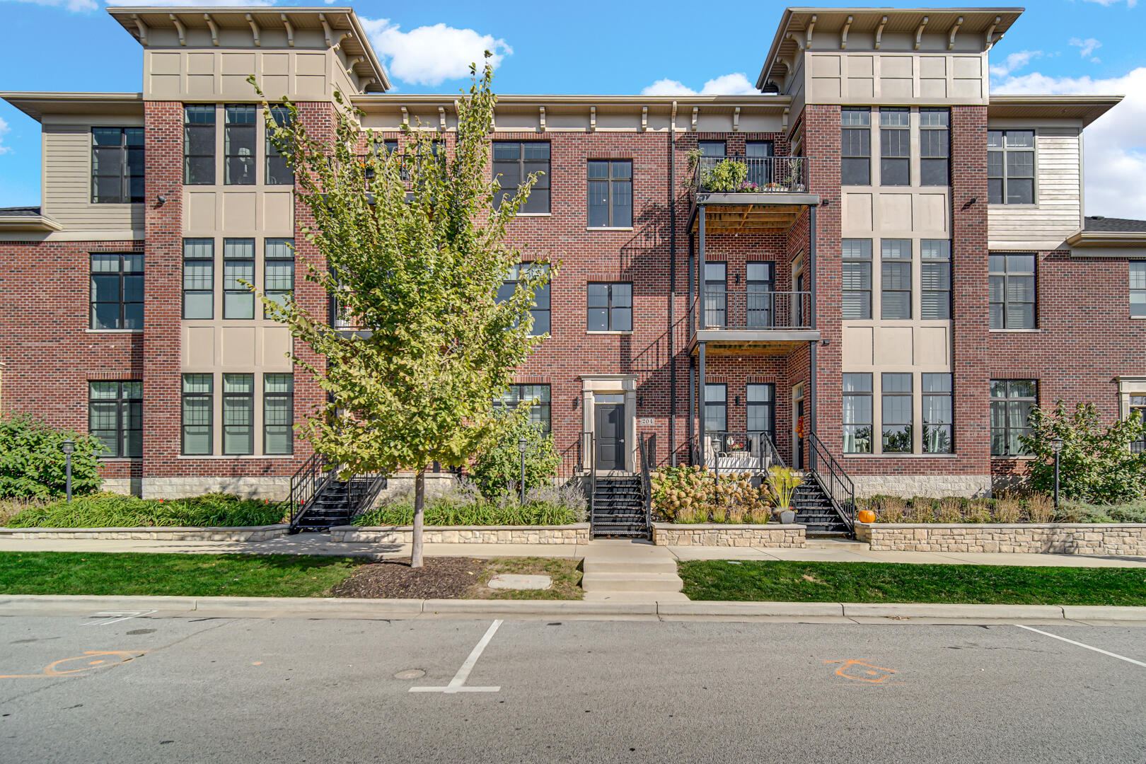 a front view of a residential apartment building with a yard