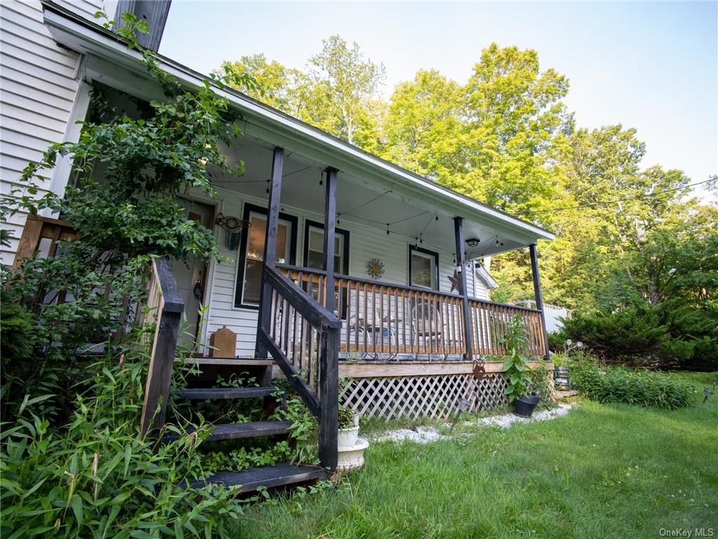 a view of a house with a yard and deck