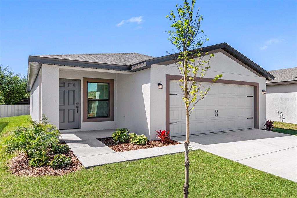 a front view of a house with a yard and garage