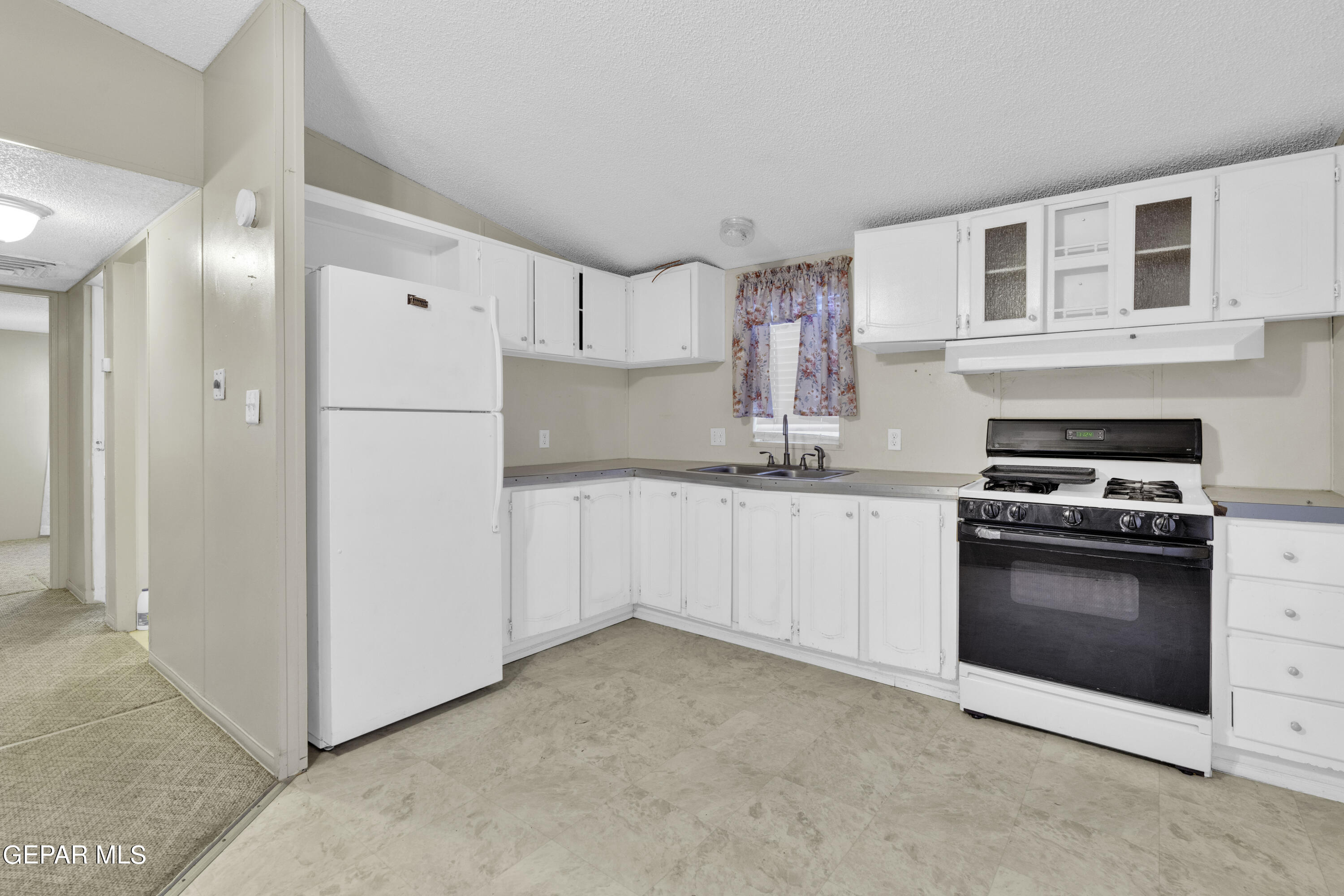 a kitchen with cabinets and stainless steel appliances