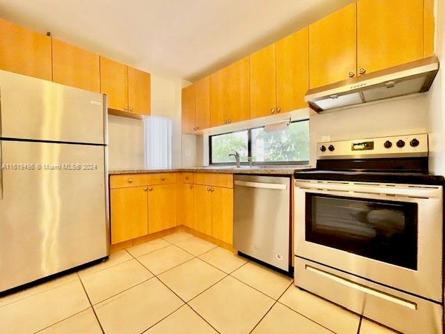 a kitchen with a stove top oven and cabinets