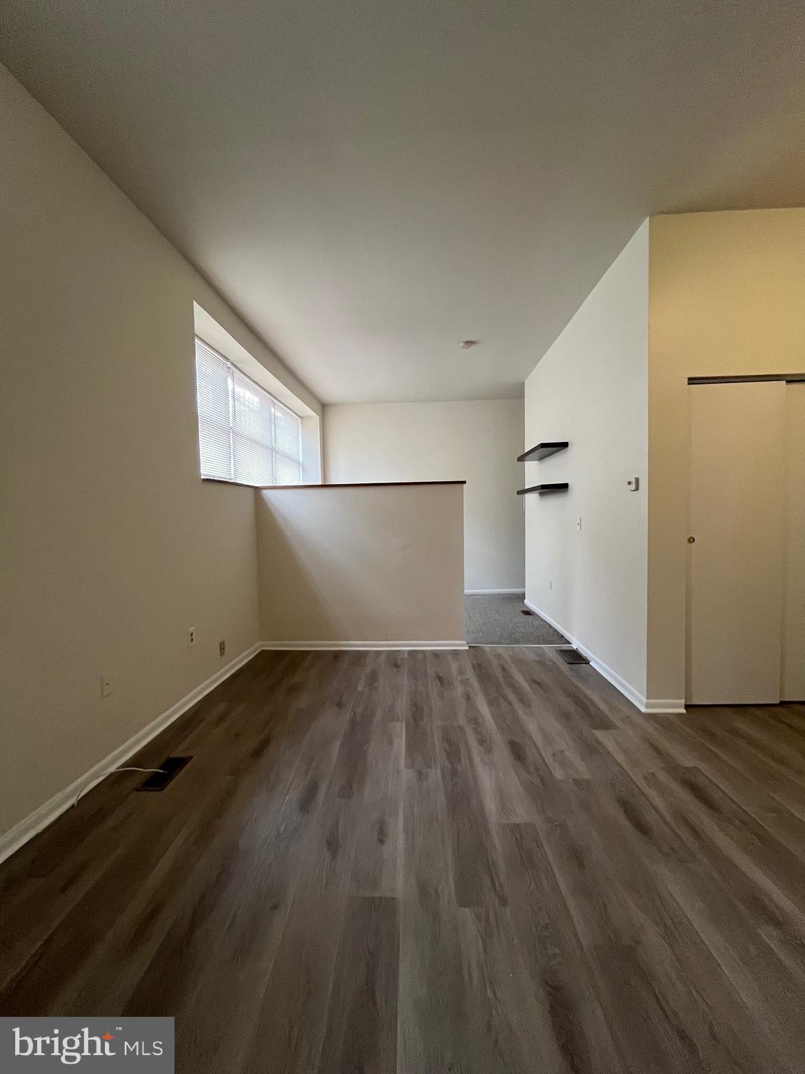 an empty room with wooden floor