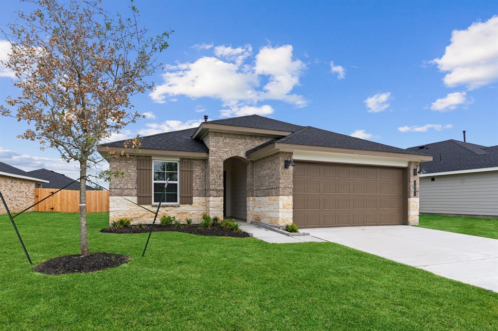 a front view of a house with a garden and yard