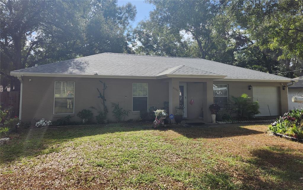 a front view of a house with a yard and porch