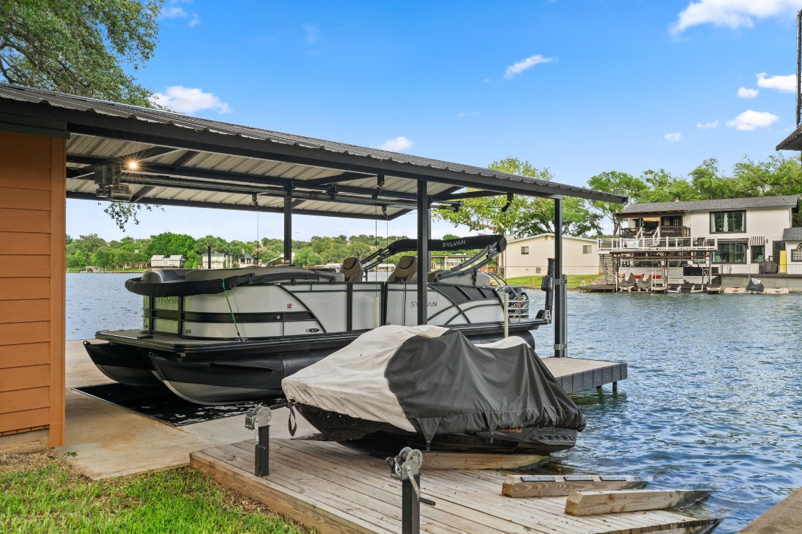 Custom boathouse with 25ft boat stall and dual waverunner hoist.