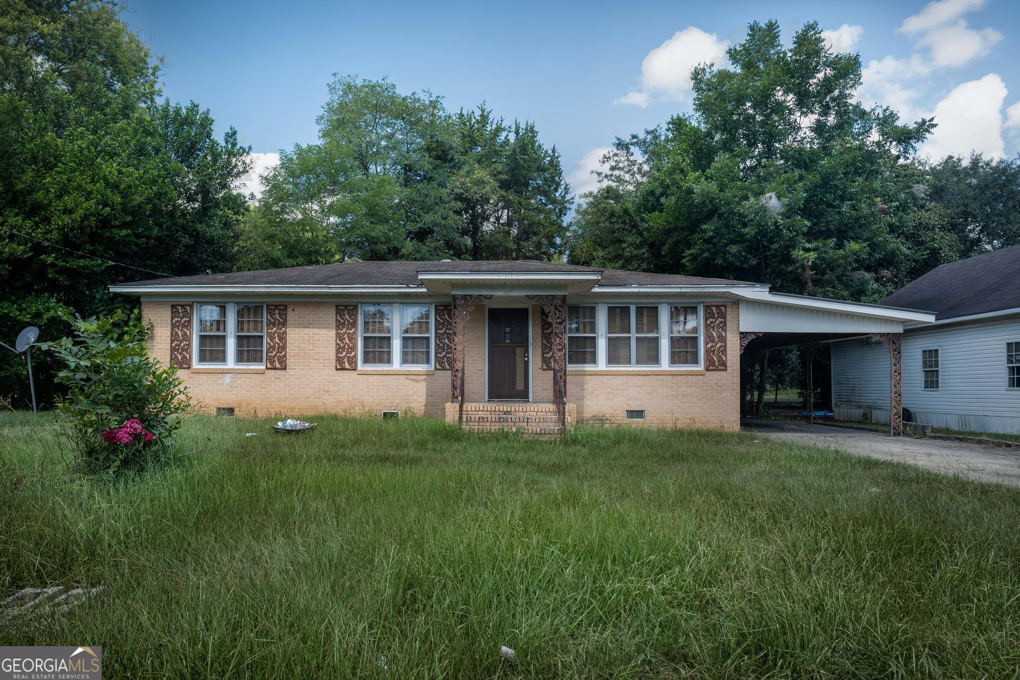 a front view of house with yard and green space