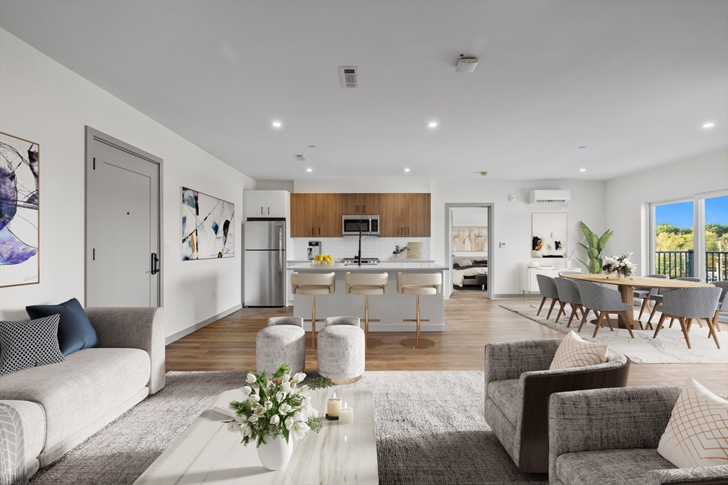 a living room with furniture kitchen view and a dining table