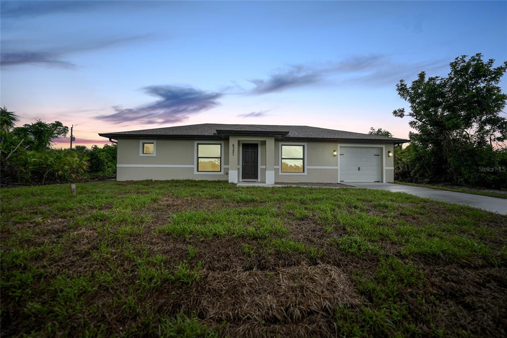 a front view of house with yard and green space